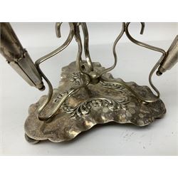 Four hallmarked silver trumpet vases, total weight 108g, upon silver plated stand with foliate decoration and bun feet