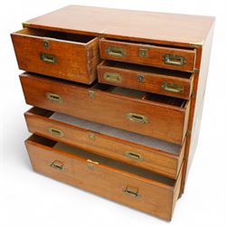 Early 19th century and later teak military campaign chest, mounted and bound with brass strapping and corner brackets, fitted with one deep, two shallow and three long drawers, each with recessed brass handles and shaped escutcheons, on turned feet 