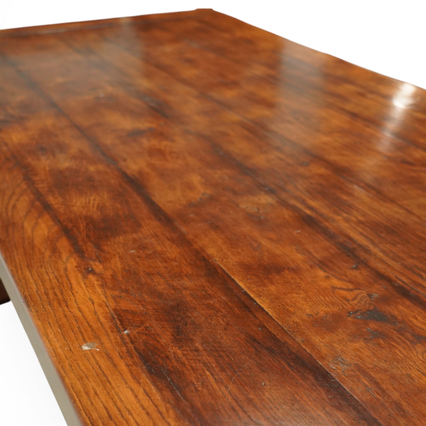 Country House 12' oak and fruitwood refectory dining table, the substantial rectangular plank top with cleated ends and chamfered edge, raised on twin trestle end square tapering and turned baluster supports with sledge feet and chamfered united by a long stretcher rail