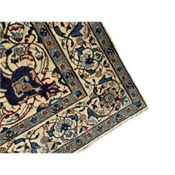 Persian Kashan ivory ground rug, wool with silk inlay, central floral rosette medallion surrounded by trailing flower heads and interlacing leafy branches, the repeating scrolling border decorated with palmettes, within guard stripes