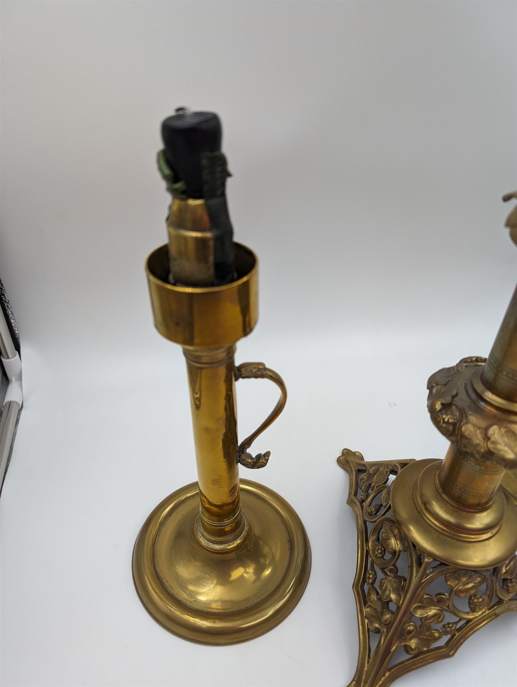 Brass candlestick with a knopt stems and triform base, together with two other brass candlestick 