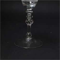 Dutch engraved Newcastle light baluster glass, circa 1760, the funnel bowl engraved with a two storey country house and church flanked by trees, beneath the inscription ‘T WELVAREN VAN LANDT ENKERK’ (The prosperity of the Country and Church), upon a multi knopped stem with beaded knop and basal knop, over conical foot, H18cm



