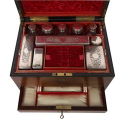  Victorian brass inlaid rosewood dressing table box, retailed by F.L. Hausburg, Liverpool, the lid centred by a brass cartouche, opening to reveal letter store to lid underside, above a fitted interior, with ten mounted cut glass jars, bottles and manicure set, within lift out leather trays, above jewellery drawer, with key, H17cm D24cm