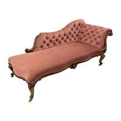 Victorian walnut framed chaise longue, deep double serpentine seat with moulded and cartouche carved apron, scrolled back carved with acanthus leaves, upholstered in pink with buttoned back, on cartouche and scroll carved cabriole supports, with brass and ceramic castors 