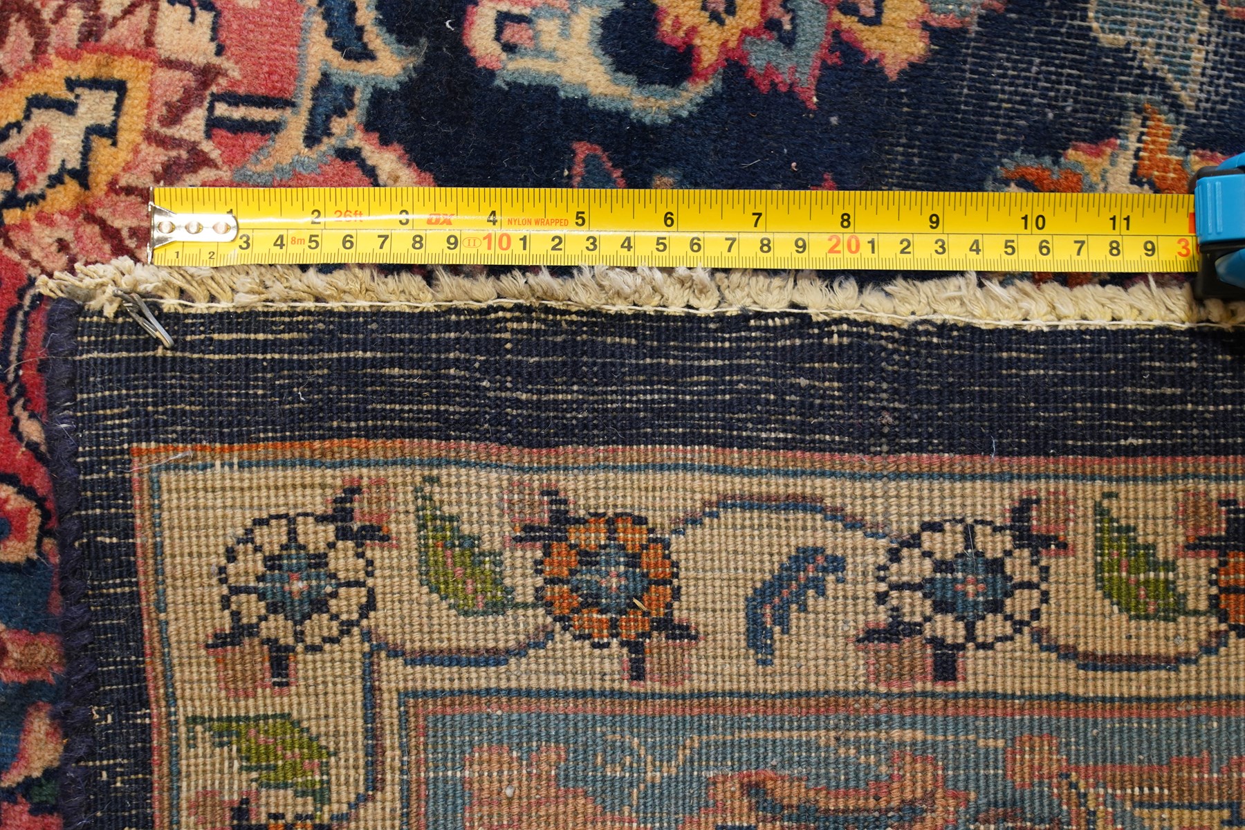 Vintage Persian Tabriz indigo ground rug, the central floral medallion within a field woven with scrolling palmettes and plant motifs, with contrasting spandrels, the the cyan guard lines with scrolling floral patterns
