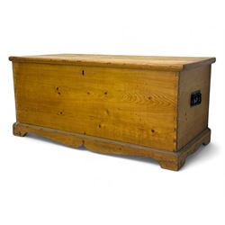 Late 19th century stripped pine blanket box, rectangular hinged lid enclosing main compartment with fitted candle box, wrought iron strap hinges and lock, black-painted side handles, on a shaped plinth base