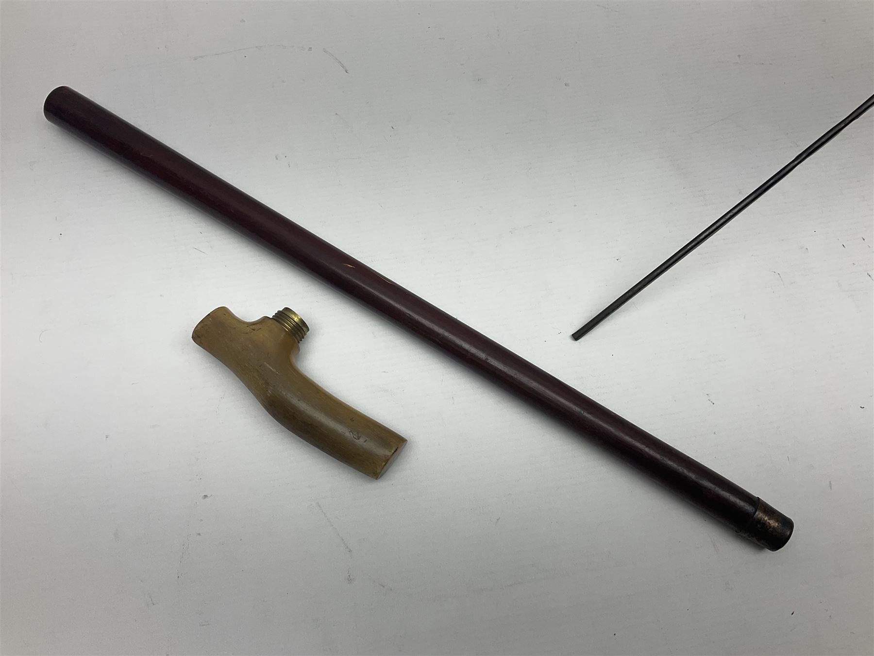 Victorian magician's cane, the mahogany walking stick twisting apart to reveal an internal mechanism, opening to tripod and black silk fold out magician's table, with horn handle and silver mount, hallmarked Birmingham 1891