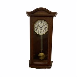 A 20th century  Westminster chime, spring driven three train “William Widdop” wall clock with a visible gridiron pendulum, chiming the hours and quarters on horizontal gong rods, white two-piece dial with roman numerals and minute track, steel spade hands, wooden case with full length glazed door and curved pediment with moulded cornice.
With key.
 
With a 20th century Westminster chime three train mantle clock with Hermle (German)  balance wheel movement chiming on four gong rods, ornate dial with Arabic numerals and minute track, contrasting black pierced steel hands, strike/silent lever.
H23cm W35cm D15cm