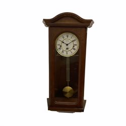 A 20th century  Westminster chime, spring driven three train “William Widdop” wall clock with a visible gridiron pendulum, chiming the hours and quarters on horizontal gong rods, white two-piece dial with roman numerals and minute track, steel spade hands, wooden case with full length glazed door and curved pediment with moulded cornice.
With key.
 
With a 20th century Westminster chime three train mantle clock with Hermle (German)  balance wheel movement chiming on four gong rods, ornate dial with Arabic numerals and minute track, contrasting black pierced steel hands, strike/silent lever.
H23cm W35cm D15cm
