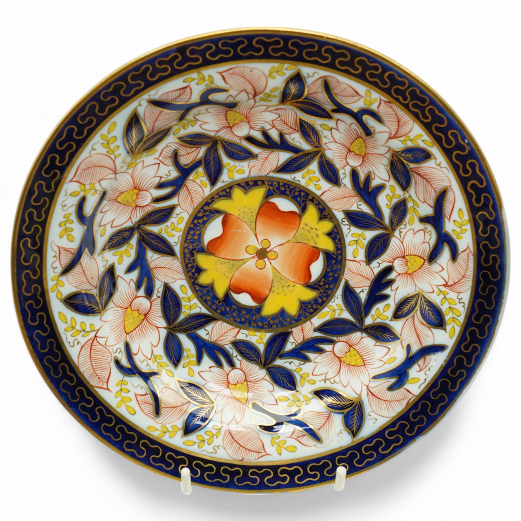 English porcelain Imari tea and coffee wares, pattern 1277, decorated with central orange floral motif surrounded by sprigs of yellow foliage within blue borders, comprising eleven teacups, eight coffee cups, twelve saucers, two shallow bowls and one finger bowl