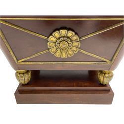 Attributed to Gillows - Regency mahogany wine cooler, the rolled moulded edge with cavetto underside, the four panelled sides decorated with applied moulded gilt rosettes and giltwood slips, with gilt lining, raised on lobe carved feet with gilt finish, upon a stepped plinth base
