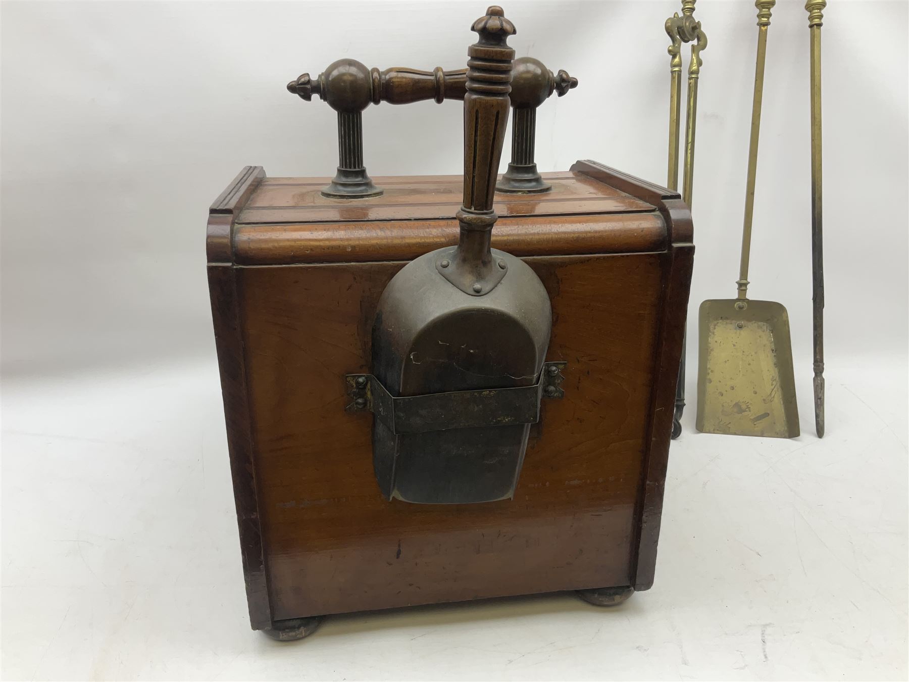 Victorian mahogany coal scuttle, the domed rolling lid carved with ornate foliate motifs opening to reveal interior with twin handled liner, mounted with carrying handle and shovel, together with brass fireside tools, largest H46cm