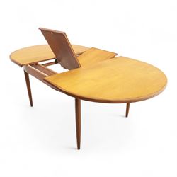 G Plan - mid-20th century teak extending dining table, oval top with integrated extension leaf, raised on tapering legs, together with a set of six slat back dining chairs including two carvers, upholstered in dark green velour (Extends to 210cm)