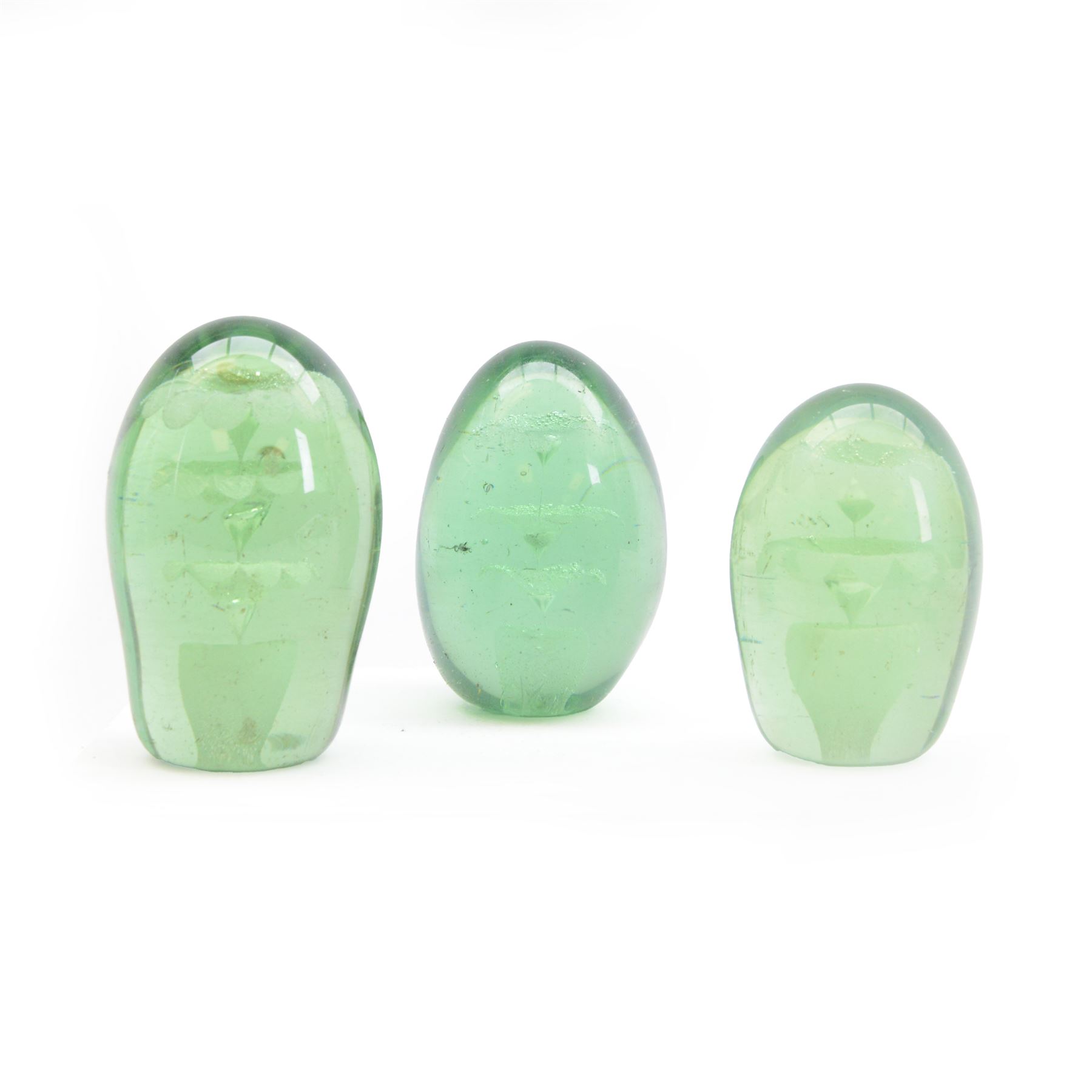 Three Victorian green glass dump paperweight with floral sulphur inclusions, H14cm