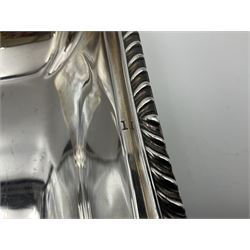 Early 20th century silver entree dish and cover, of rectangular form with shaped corners and oblique gadrooned borders to base and cover, the cover with loop 'bamboo' handle, hallmarked Thomas Bradbury & Sons Ltd, Sheffield 1930, including handle H10.5cm L24.5cm