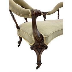 Mid-19th century rosewood framed settee, double spoon open back, carved detail, upholstered seat and back rail, on castors