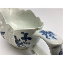 Large 18th century Lowestoft sauce boat, circa 1770, the body decorated with Hughes type floral moulding, and painted in underglaze blue with an Oriental landscape, and foliate sprigs, L23cm