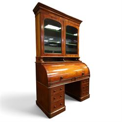 Victorian mahogany cylinder roll-top bookcase-secretaire, projecting cornice over twin glazed doors enclosing two shelves, the cylinder roll-top enclosing fitted interior with sliding drawer, hinged compartments, correspondence drawers and pigeon-holes, the twin pedestals fitted with three graduating drawers to each side, on plinth bases with castors