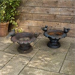 Pair of small cast iron circular squat urns or bird baths, each with two bird perched on t...
