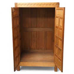 Mouseman - Oak 5' x 3' wardrobe, circa 1950s, scalloped cornice, panelled sides and front, twin doors with wrought metal latch and hinges, raised on stile supports with carved mouse to left hand side, by the workshop of Robert Thompson, Kilburn

Provenance - this lot comes to us for sale from direct descent of Robert Thompson. Thompson is the great grandfather of the vendor.
