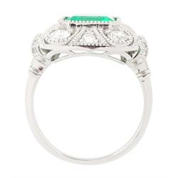 Platinum emerald and diamond cluster ring, single octagonal cut emerald of 2.52 carat, surrounded by milgrain set round brilliant cut and single cut diamonds, stamped PT950, total diamond weight 0.82 carat