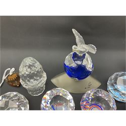Swarovski Crystal paperweights, to include a globe with dove to the top, pyramid shapes etc, together with a large collection of boxes and stands  