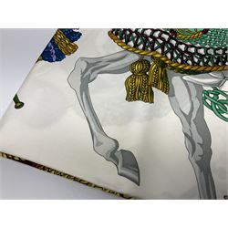 Hermès 'Le Timbalier' silk scarf, designed by Francoise Heron in 1961, printed with a central image of a gentleman on horseback donning extravagant dress, on white ground surrounded with colourful stylised knotted ropes, contained within peacock blue border, with rolled hand stitched edges and Hermes material label, 87cm square