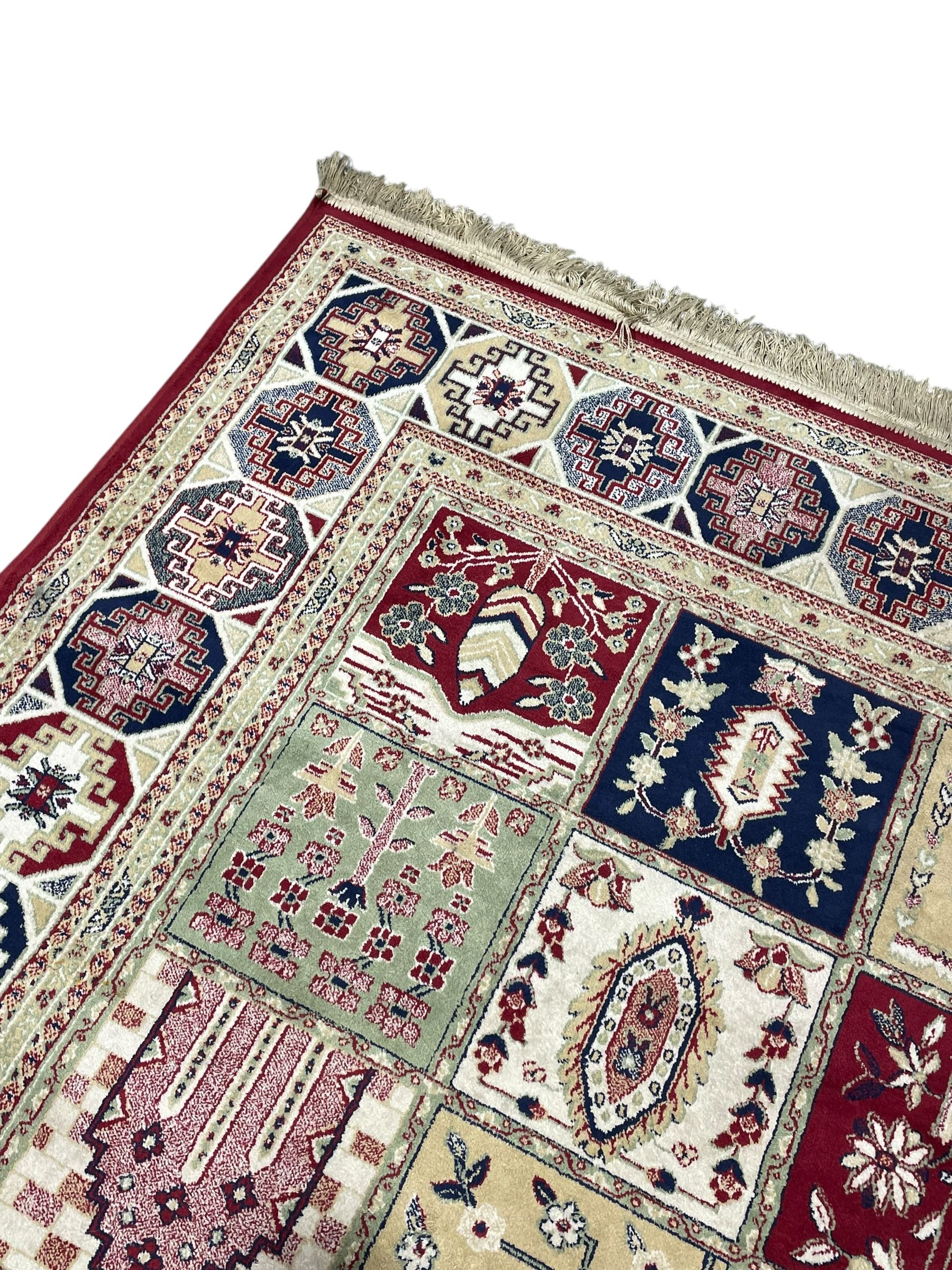 Bakhtiari design rug, the field divided into panels each decorated with tree of life and floral motifs, the main border decorated with Hac motifs 