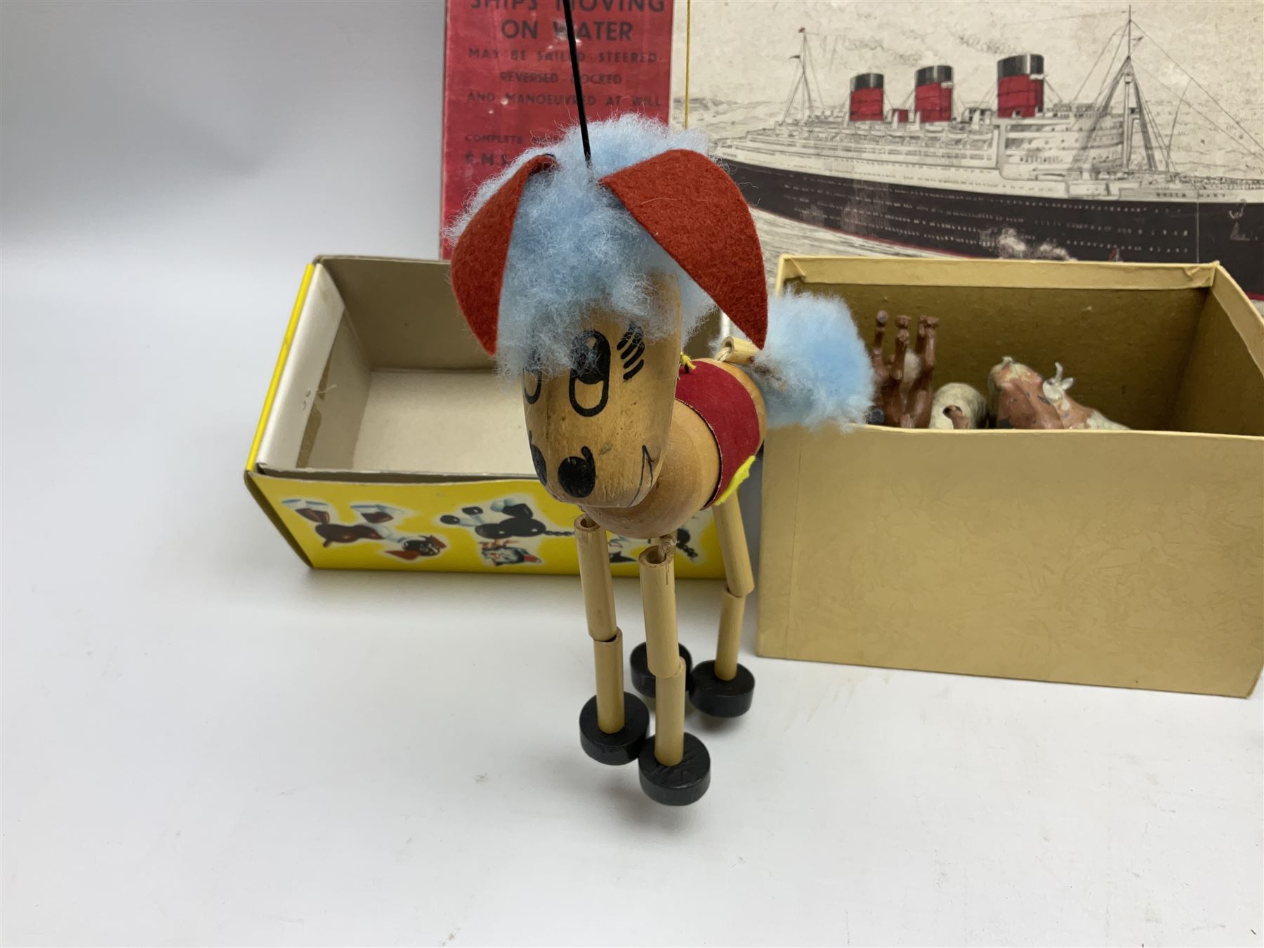 Vintage toys comprising 'Docking RMS Queen Mary' game, two boxed Pelham puppets, quantity of painted metal British soldiers to include Guardsmen, painted farm animal figures