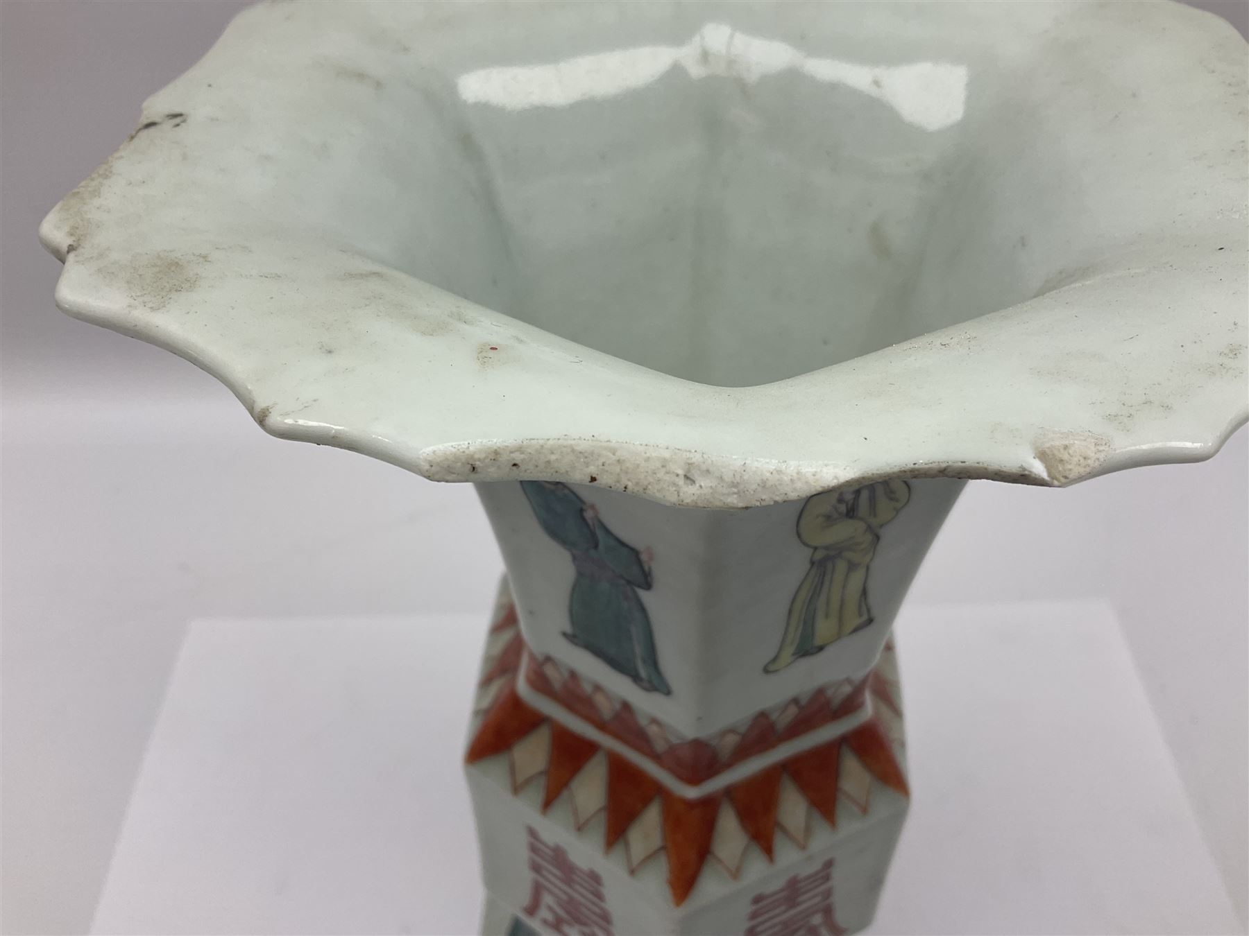 Chinese Kangxi gu vase, of hexagonal form with fluted rim, decorated in polychrome enamels with a male figure to each panel and red character marks to centre, with painted red leaf mark beneath, H32.5cm