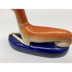 Pair of Staffordshire recumbent greyhound pen holders 