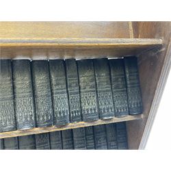 Miniature works of William Shakespeare c.1930, black faux leather covers, housed in a three tier open trough bookcase, pub. Allied Newspapers, H22cm