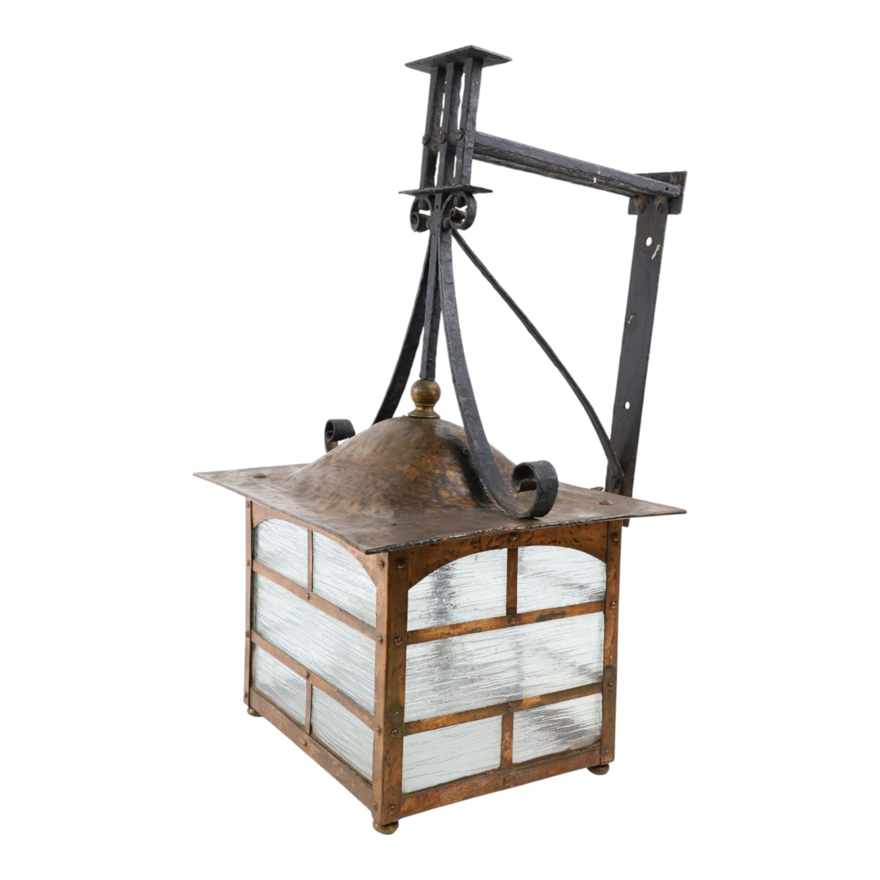 20th century, Arts and Crafts style copper porch lantern, of rectangular form, with cast iron scrolling wall fittings
