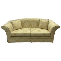 Three-seat hardwood framed sofa, traditional shape with arched cresting rail over rolled arms, upholstered in pale gold and cream damask fabric with repeating foliate pattern