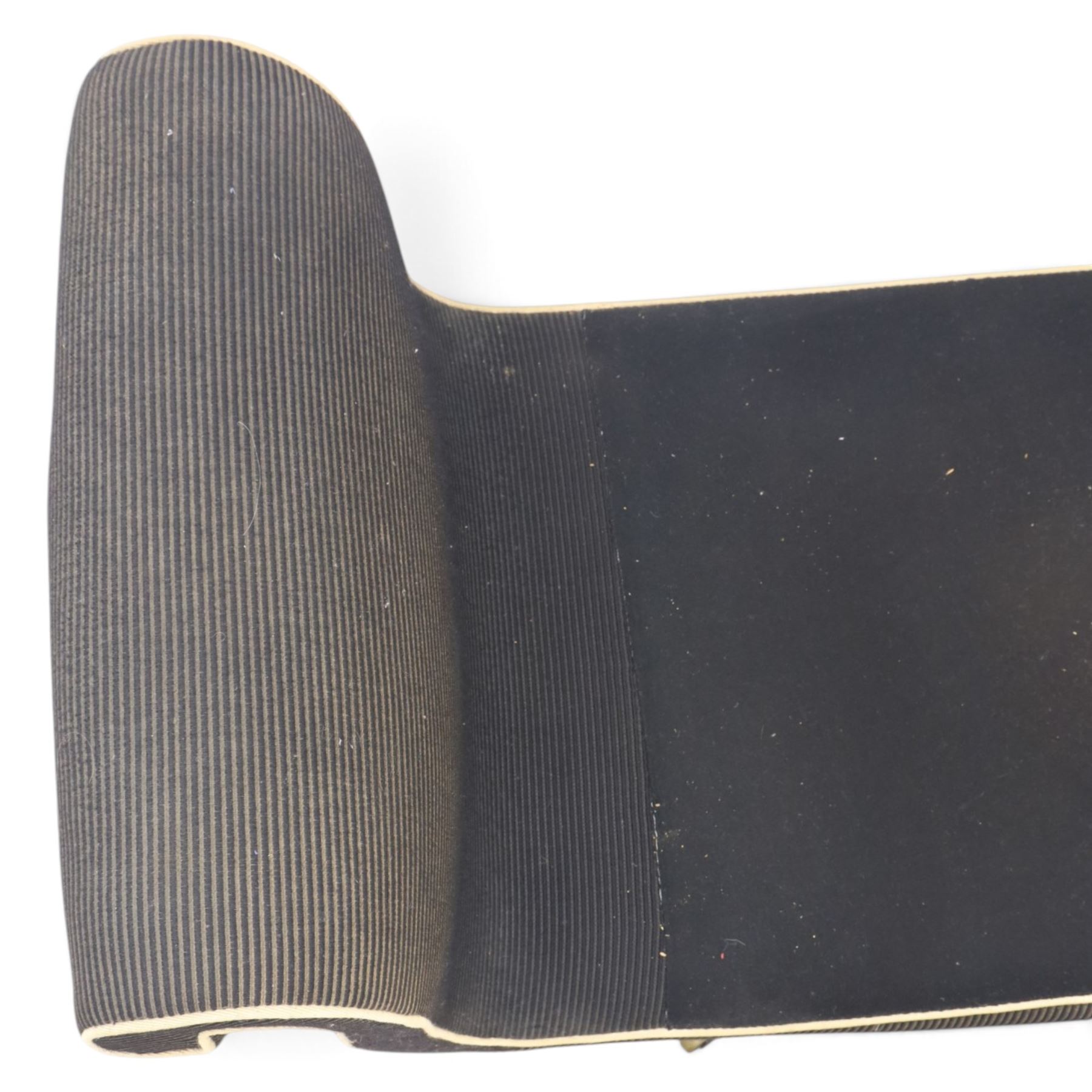 Victorian ebonised chaise longue, upholstered in black fabric with scroll headrest and bolster cushion, rectangular seat with rounded corners, raised on turned supports terminating in brass and ceramic castors