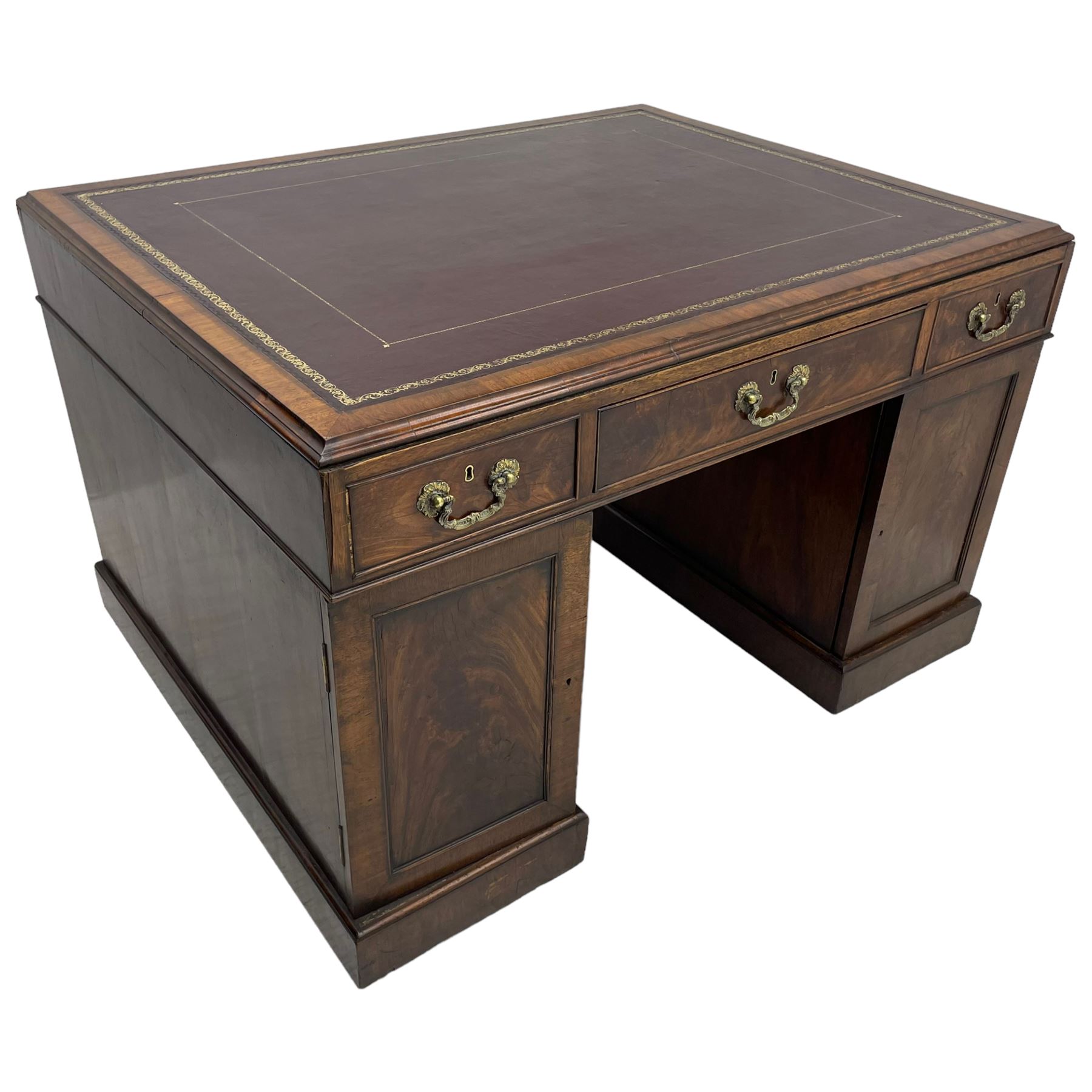 George III mahogany twin pedestal partner's desk, moulded rectangular caddy top with tooled leather inset, one side fitted with nine drawers and the opposing side fitted with single drawer, two false drawers and two panelled cupboards, ornate cast gilt metal handles and handle plates, on plinth base