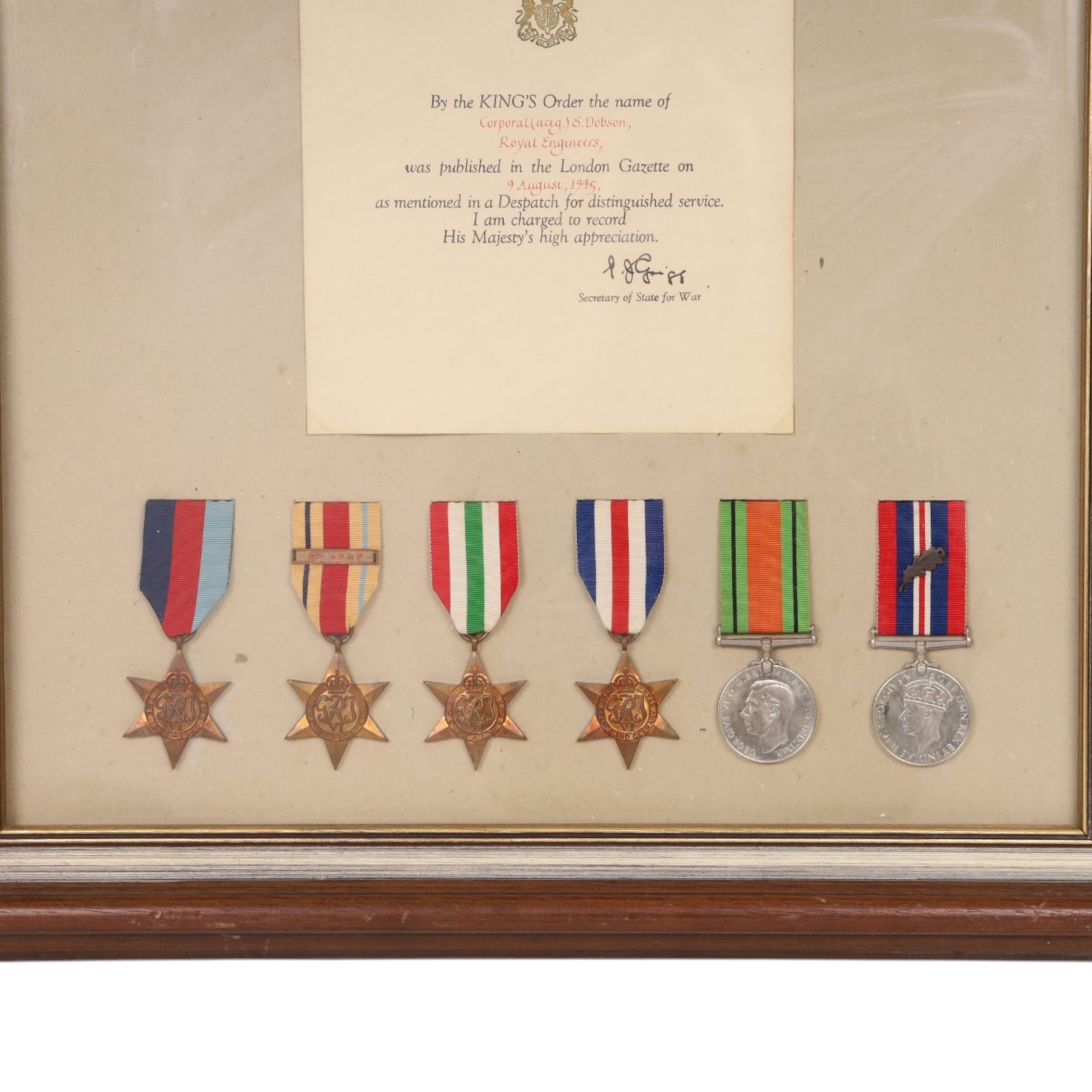 WWII British medal group, composing 1939-1945 Star, African Star, Italian Star, French and German Star, Defence medal and War medal with oak leaf clasp, awarded to Corporal S Dobson Royal Engineers, framed, with Royal Engineers shoulder badge and a mentioned in dispatches certificate, H58cm,W49cm 