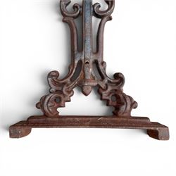 Pair of Victorian cast iron table end supports, of pierced and scrolling foliate design with central masks, united by X-form stretcher, with later top