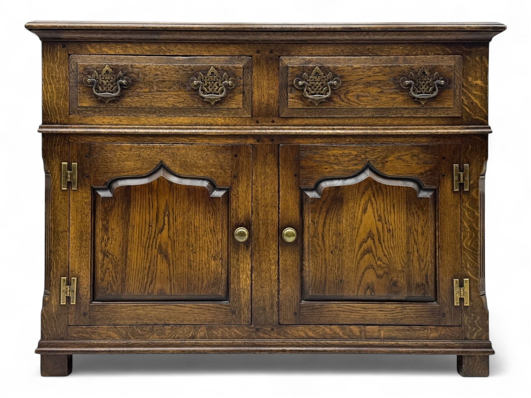 Early 20th century Jacobean design oak dresser sideboard, rectangular top with moulded edge over two baize-lined drawers with pierced handles, above two fielded panel cupboard doors, on stile supports