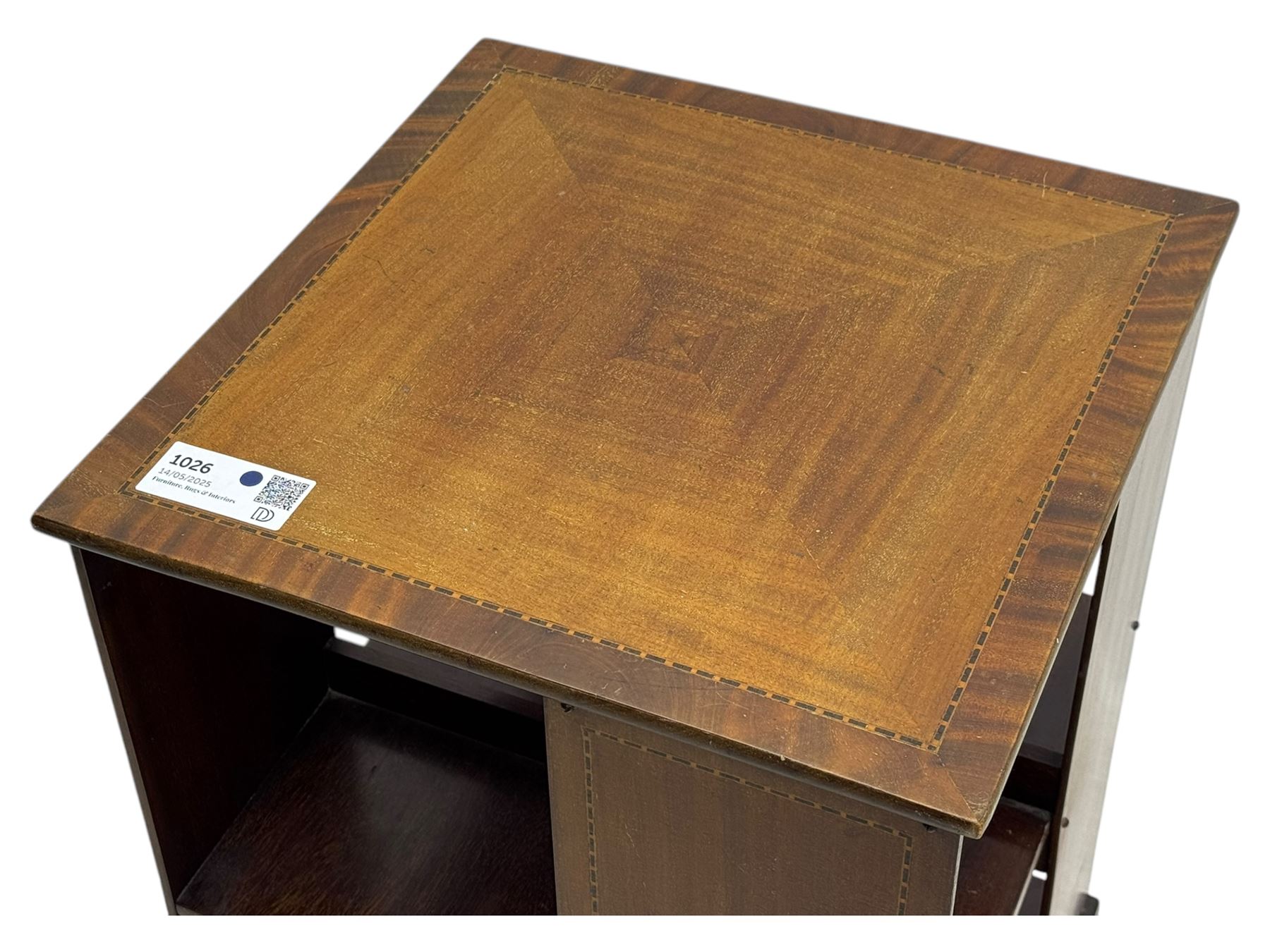 Edwardian inlaid mahogany revolving bookcase, square top, two tier open book compartments, on a cruciform base with splayed feet 