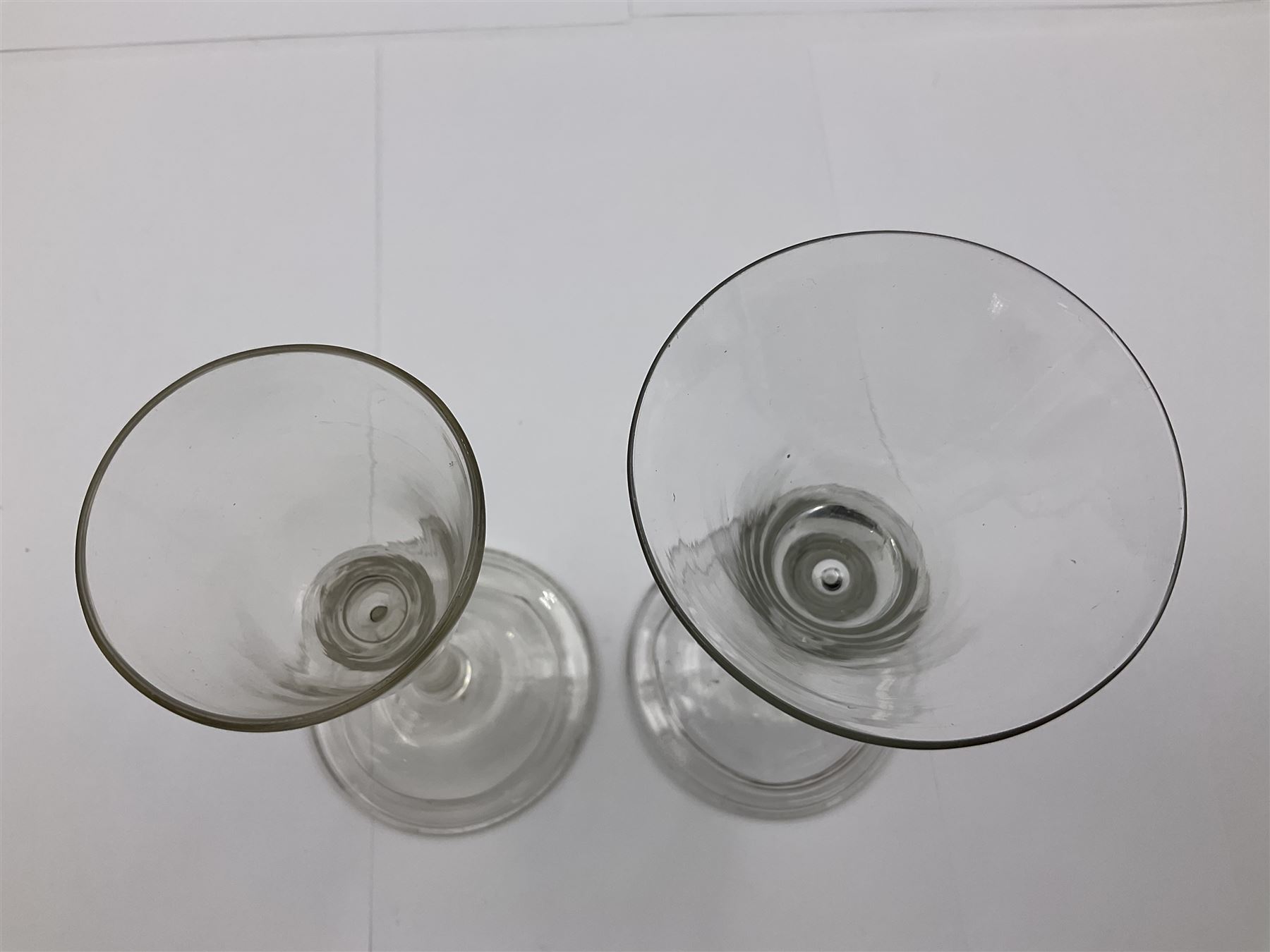 18th century wine glass, the trumpet shaped bowl upon tear drop stem and conical folded foot, H15.5cm, together with an 18th century cordial glass, the round funnel bowl on plain knopped stem and folded conical foot