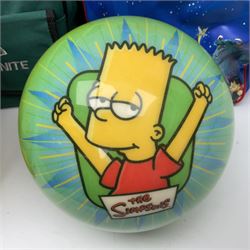 Two The Simpsons 'The Bowling Club' tenpin bowling balls, the first an undrilled example depicting Bart Simpson on a green ground, the second a drilled example depicting the Simpsons family on an orange ground, both in Simpsons The Bowling Club bags, together with a Disney Monsters, Inc. tenpin bowling ball, in matching bag and a Maxim tenpin bowling ball