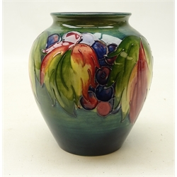  Moorcroft Grape and Leaf pattern baluster vase on green ground, with label to base, H13cm   