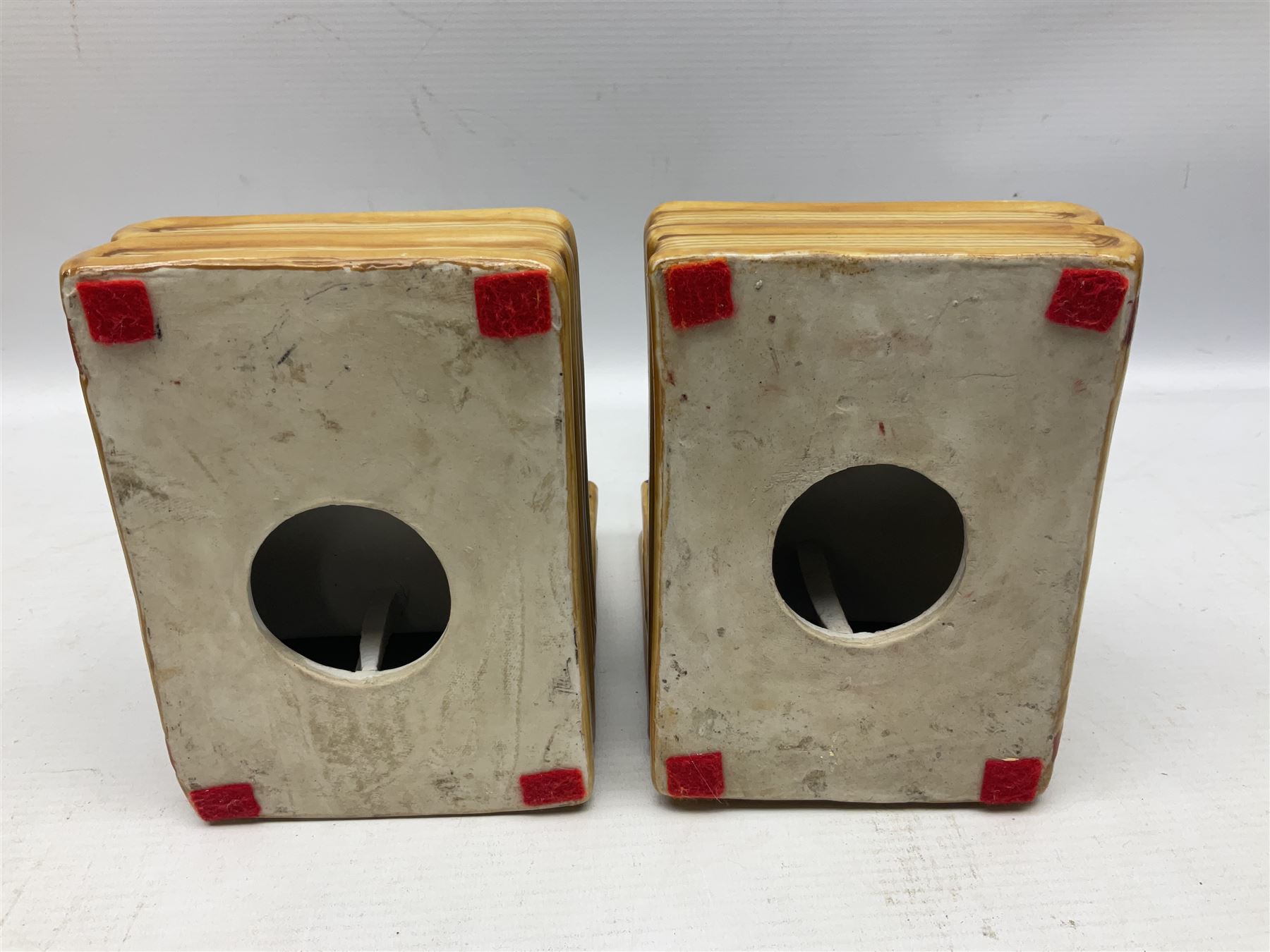 Pair of 20th century Chinese figural bookends, modelled as children in traditional blue dress sat reading and kneeling upon stacks of books, H22cm