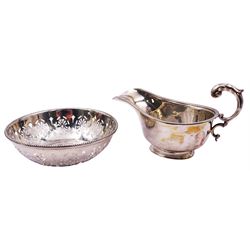 1930's silver sauce boat, of typical plain form with acanthus capped flying scroll handle, hallmarked William Henry May, Birmingham 1931, including handle H9cm, together with a 1920's silver bowl, with patera pierced sides and beaded rim, hallmarked Walker & Hall, Sheffield 1922, D12.5cm, approximate total weight 4.79 ozt (149 grams)