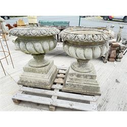 Pair of large weathered Country House Haddonstone garden urns, acanthus carved rim above gadrooned bowl, beaded detailing to the neck, raised on stepped double plinth base
