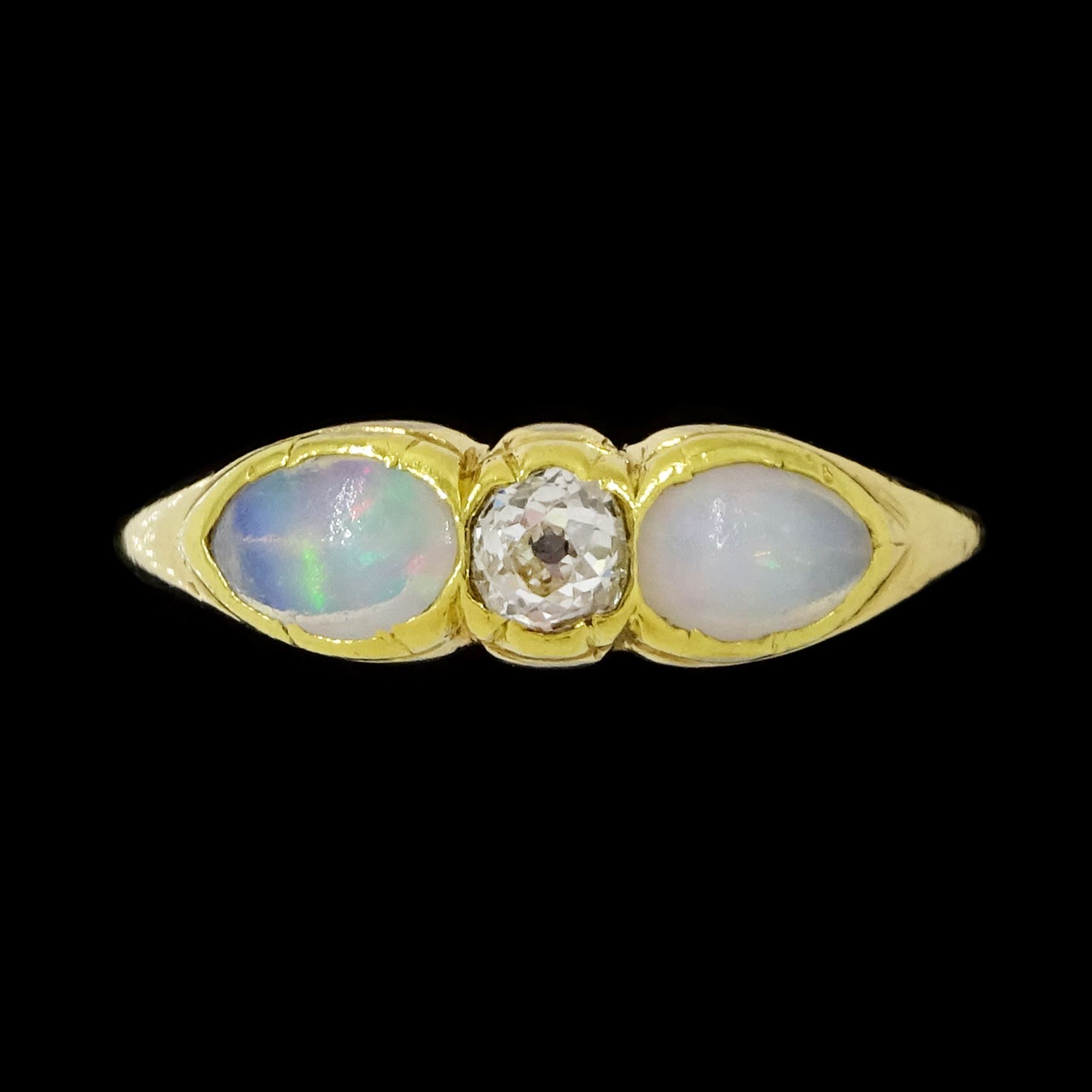 Early 20th century gold opal and diamond three stone ring, single old cut diamond of approx 0.10 carat, with a single cabochon pear cut opal set either side