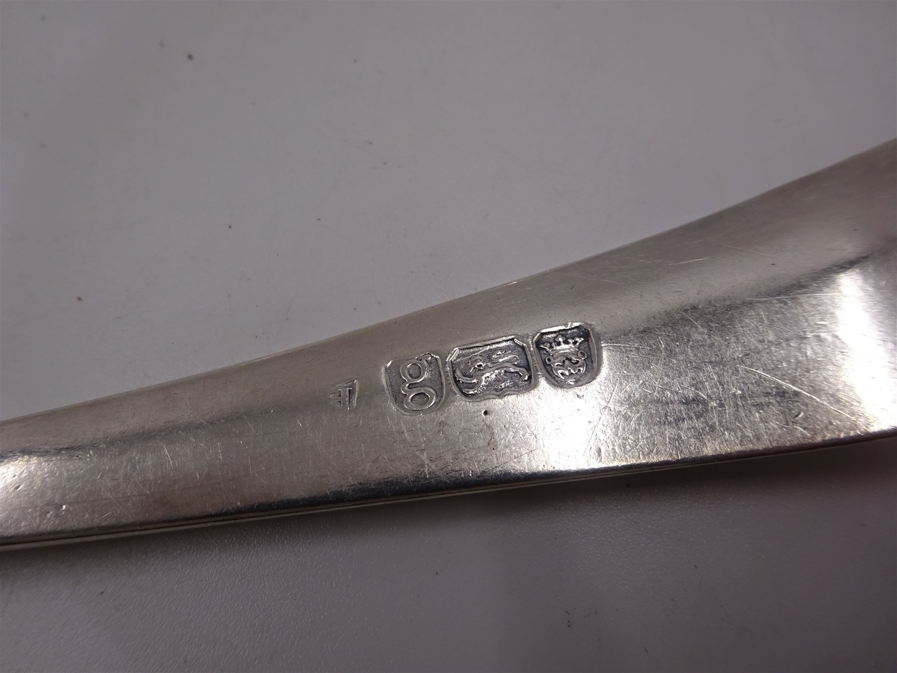 Five George III silver table spoons, to include an Old English pattern example, with engraved initials to terminal, hallmarked Hester Bateman, London 1780, together with an Old English pattern table spoon, engraved with leopard in shield shaped cartouche to terminal, bordered by foliate decoration, hallmarked London 1782, maker's mark worn and indistinct and a Hanoverian pattern table spoon, with engraved initial verso, hallmarked Robert Sallam, London 1770, etc