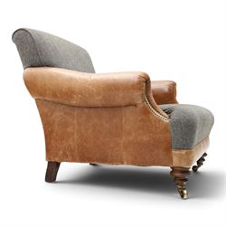 Tetrad - 'Taransay' Harris Tweed and tan leather club armchair, Howard shape with reclined back over deep seat and rolled arms with studwork, raised on turned front supports with castors, the sides and arms upholstered in tan leather with seat and back in herringbone-stitched Harris Tweed
