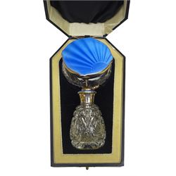 Art Deco thirteen piece silver mounted blue guilloche enamel dressing table set, comprising two hair brushes, two clothes brushes, hand mirror, two cut glass jars, buffer and a cut glass scent bottle, hallmarked J W Tiptaft & Son Ltd, Birmingham 1930 and 1932, and a silver handled manicure set, hallmarked Daniel Manufacturing Company, Birmingham 1930, with a pair of base metal scissors, each contained within three original fitted cases with black and cream silk and velvet lined interiors, one with removable mirror